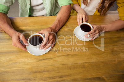 Couple holding cups of coffee