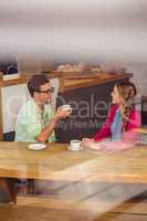 Couple interacting while drinking a coffee