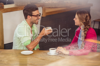 Couple interacting while drinking a coffee