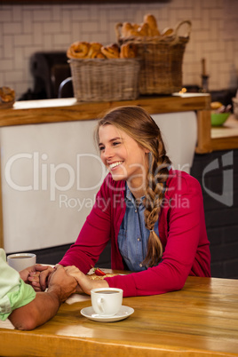 Couple holding hands in cafeteria