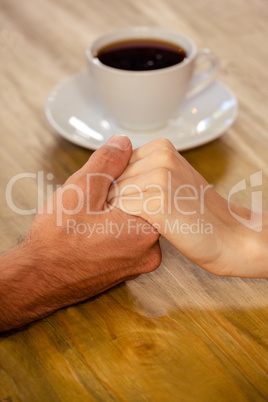 Couple holding hands in cafeteria