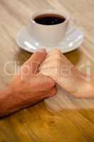 Couple holding hands in cafeteria