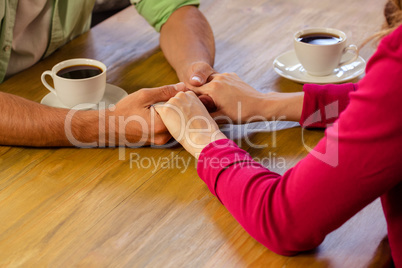 Couple holding hands in cafeteria