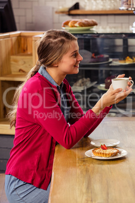 Pretty casual woman holding a cup of coffee