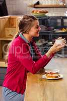 Pretty casual woman holding a cup of coffee