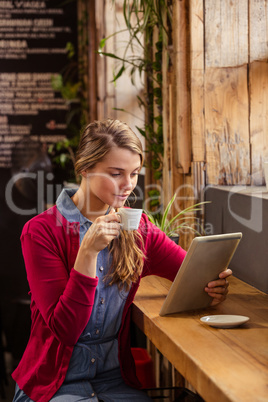 Beautiful young woman using digital tablet