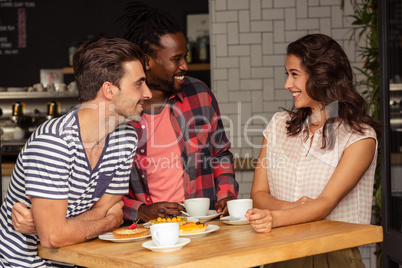 Friends talking together and smiling