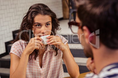 Young woman having coffee in cafeteria