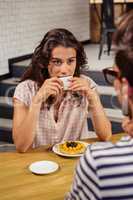 Young woman having coffee in cafeteria