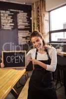 Waitress holding a sign with open