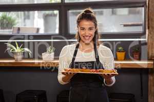 Waitress holding a tray with tartlets