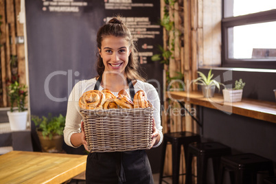 Woman holding a basket with pastries inside