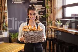Woman holding a basket with pastries inside