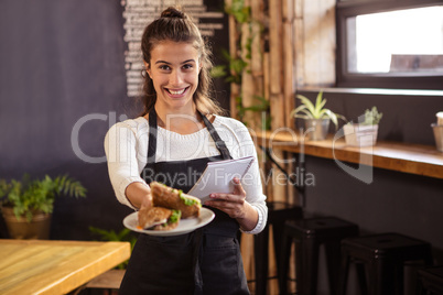 Waitress holding a plate and a clipboard