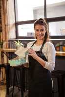 Waitress holding boxes with a cake inside