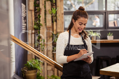 A waitress is taking the order