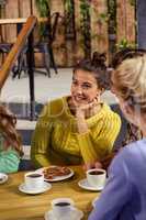 Smiling friends sitting at a table