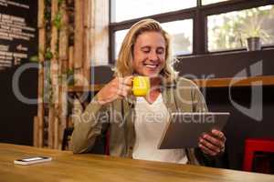 Young man using digital tablet in cafeteria