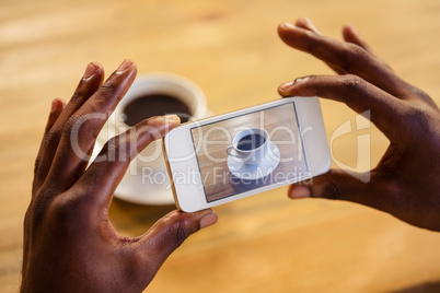 Man taking picture of a coffee