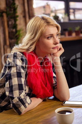 Thoughtful woman sitting at a table