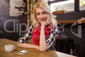 Portrait of young woman in cafeteria