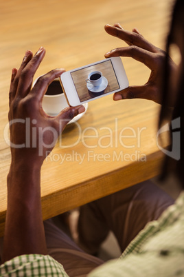 Man taking picture of a coffee