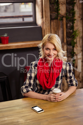 Young woman sitting in cafeteria