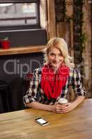 Young woman sitting in cafeteria