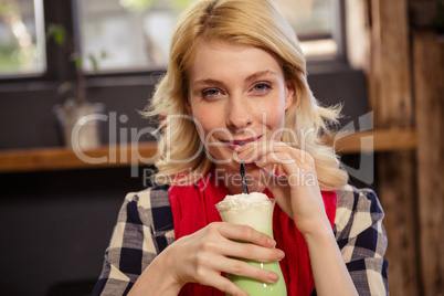 Young woman drinking mocktail