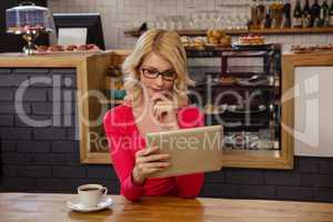 Woman using a tablet alone