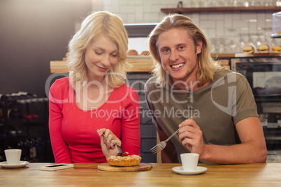 Couple eating a cake togheter