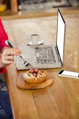 Woman eating a cake alone