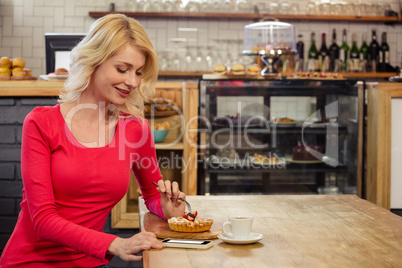 Woman eating a cake alone