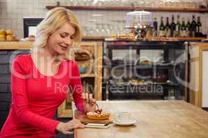 Woman eating a cake alone