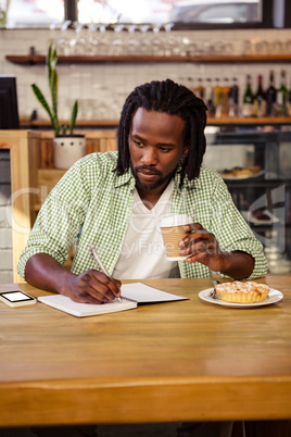 Man writing in a notebook