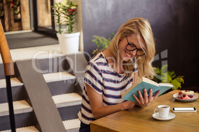 Woman reading a book sitting