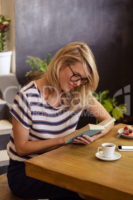 Woman reading a book sitting