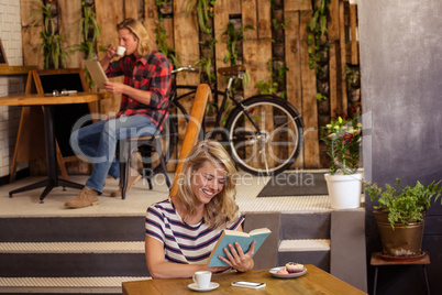 People reading book and using tablet