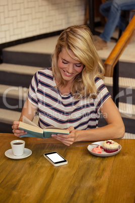 Woman reading a book sitting