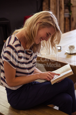 Woman reading a book sitting