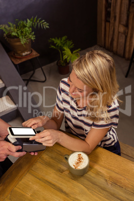 Woman paying with mobile payment