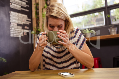 Woman drinking a hot beverage