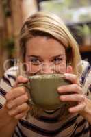 Woman drinking a hot beverage
