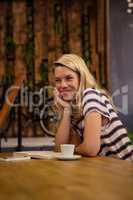 Woman sitting at a table sitting and smiling