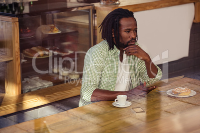 Thoughtful man using tablet