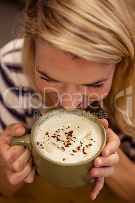 Woman drinking a hot beverage