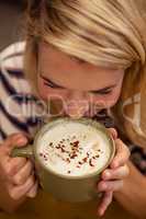 Woman drinking a hot beverage