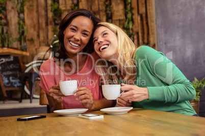 Friends holding a cup of coffee