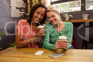 Friends holding a coffee