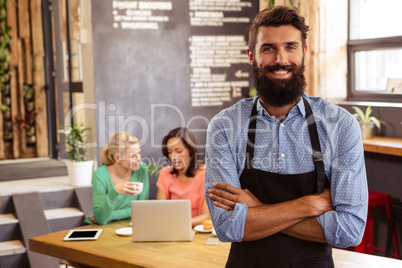 Waiter standing with arms crossed